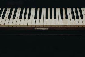 Home A close-up view of vintage piano keys showcasing the wear and character of the instrument.