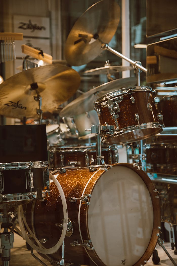 gallery-6 Detailed view of a sparkling drum set in a music store with cymbals, showcasing musical instruments.